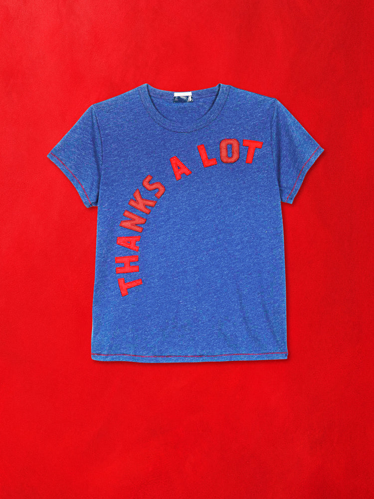 A flat product image of blue tee featuring a red graphic against a red background.