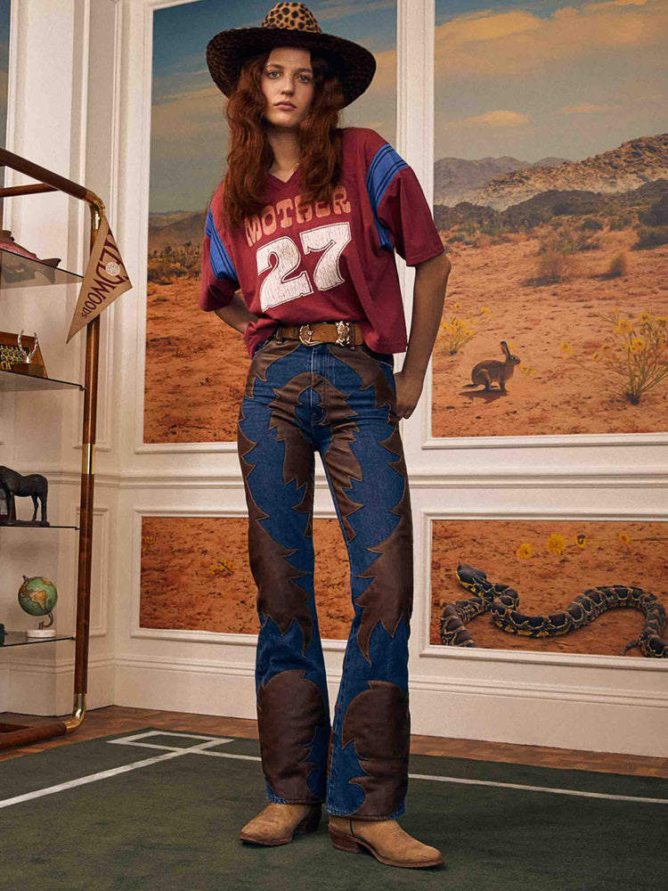 Editorial image of a woman super high waisted bootcut jeans.