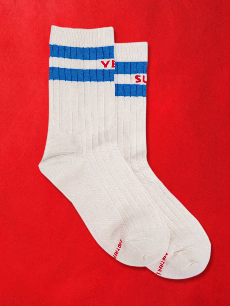 A flat product image of a pair of white socks with blue stripes against a red background.